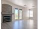 Open living room features wood flooring, fireplace and natural light from the doors to the backyard at 1960 Verbania Dr, Las Vegas, NV 89134
