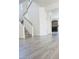 Bright and airy living room featuring hardwood floors, a staircase, and a cozy fireplace at 1960 Verbania Dr, Las Vegas, NV 89134