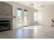 Bright living area with hardwood flooring, fireplace, and French doors leading to the backyard at 1960 Verbania Dr, Las Vegas, NV 89134
