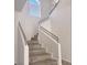 Elegant staircase featuring hardwood steps, modern railing, and ample natural light from above at 1960 Verbania Dr, Las Vegas, NV 89134
