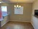 Dining room with tile flooring and a modern chandelier at 2105 William Holden Ct, Las Vegas, NV 89142