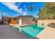 Backyard pool with a diving board; the yard is surrounded by mature trees and greenery at 2211 Frontier Ave, Las Vegas, NV 89106