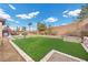 Expansive backyard with lush artificial grass, providing a low-maintenance and beautiful outdoor space at 2436 Chateau Napoleon Dr, Henderson, NV 89044