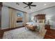 Elegant main bedroom with tray ceilings, a ceiling fan, and hardwood floors at 2436 Chateau Napoleon Dr, Henderson, NV 89044