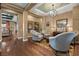 Cozy sitting area with comfortable chairs, elegant decor, and hardwood flooring at 2436 Chateau Napoleon Dr, Henderson, NV 89044