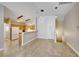 Open layout connects living area to the kitchen with modern tile flooring and neutral color palette at 2589 Velez Valley Way, Henderson, NV 89002