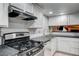 Bright kitchen with stainless appliances, black countertops, and a ceramic tile backsplash at 2641 Ruthe Duarte Ave, Las Vegas, NV 89121