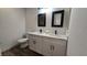 Bathroom with double vanity, marble counters, and black modern fixtures at 2851 S Valley View Blvd # 1098, Las Vegas, NV 89102