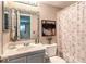 Bathroom featuring a tile backsplash, vanity, toilet, decorative art, and patterned shower curtain at 328 S Buffalo Dr # 101, Las Vegas, NV 89145