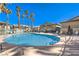 Community pool with lounge seating and palm trees surrounding it, perfect for relaxation at 328 S Buffalo Dr # 101, Las Vegas, NV 89145
