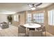Staged dining area with modern chairs, a round table and a ceiling fan at 328 S Buffalo Dr # 101, Las Vegas, NV 89145