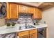 Kitchen boasts a modern tiled backsplash, double sink, and bright countertops at 328 S Buffalo Dr # 101, Las Vegas, NV 89145