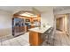 Kitchen includes stainless steel refrigerator, breakfast bar, and natural wood cabinets at 328 S Buffalo Dr # 101, Las Vegas, NV 89145