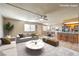 Spacious, staged living room seamlessly flows into dining area and kitchen at 328 S Buffalo Dr # 101, Las Vegas, NV 89145