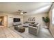 Staged living room with modern furniture, a ceiling fan, and plank flooring at 328 S Buffalo Dr # 101, Las Vegas, NV 89145