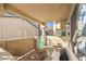Covered, virtually staged patio with outdoor seating, a view and an outdoor gate at 328 S Buffalo Dr # 101, Las Vegas, NV 89145
