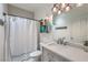 Bathroom featuring a shower with a tub, vanity and modern lighting fixtures at 3305 Fernbird Ln, North Las Vegas, NV 89084