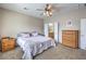Bedroom with carpet, a ceiling fan, dressers, and access to the bathroom at 3305 Fernbird Ln, North Las Vegas, NV 89084