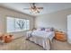 Comfortable bedroom with natural light, ceiling fan, carpet, and neutral tones at 3305 Fernbird Ln, North Las Vegas, NV 89084