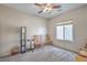 Bedroom features neutral walls, a ceiling fan, a window, and carpeted flooring at 3305 Fernbird Ln, North Las Vegas, NV 89084