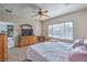 Bedroom with carpet, a ceiling fan, a view of the dining area, and natural light at 3305 Fernbird Ln, North Las Vegas, NV 89084