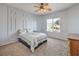 Cozy bedroom with decorative wall, ceiling fan, and a large window allowing natural light at 3305 Fernbird Ln, North Las Vegas, NV 89084