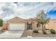 Charming single-story home featuring desert landscaping, a two-car garage, and a tile roof at 3305 Fernbird Ln, North Las Vegas, NV 89084