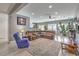 Spacious living room with wood floors, a large sectional couch, and natural light at 3305 Fernbird Ln, North Las Vegas, NV 89084