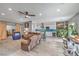 Expansive living room and open kitchen with white cabinets, stainless appliances, and hardwood style floors at 3305 Fernbird Ln, North Las Vegas, NV 89084