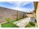 Lush backyard landscaping with gravel paths and privacy wall at 3425 Conan St # 103, Las Vegas, NV 89129