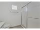 Bathroom with a walk-in shower, grey tile floor, and crisp white walls at 3425 Conan St # 103, Las Vegas, NV 89129
