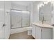 Bathroom featuring modern vanity, framed mirror, a shower-tub combo, and tile flooring at 3425 Conan St # 103, Las Vegas, NV 89129