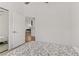 Minimalist bedroom featuring a mirrored closet and white door leading to kitchen at 3425 Conan St # 103, Las Vegas, NV 89129