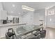 Open-concept kitchen and entryway featuring modern table with seating and stainless steel appliances at 3425 Conan St # 103, Las Vegas, NV 89129