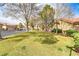 Well-manicured front yard with lush green grass and mature trees enhancing curb appeal at 3425 Conan St # 103, Las Vegas, NV 89129