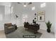 Staged home office with vaulted ceiling, fan, modern desk, and a comfortable chair at 3425 Conan St # 103, Las Vegas, NV 89129