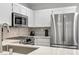 Kitchen featuring stainless steel appliances, stone backsplash, and white countertops at 3425 Conan St # 103, Las Vegas, NV 89129