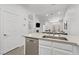 Bright open-concept kitchen with stainless dishwasher, countertops, cabinets and a large sink at 3425 Conan St # 103, Las Vegas, NV 89129