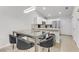 Modern white kitchen with stainless steel appliances, ample counter space, and an island with seating at 3425 Conan St # 103, Las Vegas, NV 89129