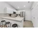Well-lit kitchen featuring stainless steel appliances, white cabinetry, and bar stool seating at 3425 Conan St # 103, Las Vegas, NV 89129