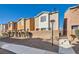 Townhome exterior showcasing colorful facades, neatly trimmed shrubs, and clear blue skies at 4052 Rocky Beach Dr, Las Vegas, NV 89115