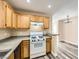 The kitchen has wood cabinets, stone countertops, and white appliances at 4052 Rocky Beach Dr, Las Vegas, NV 89115