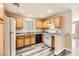 Kitchen features wood cabinets, granite countertops, and modern appliances at 4052 Rocky Beach Dr, Las Vegas, NV 89115
