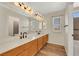 Primary bathroom boasts dual sinks, a spacious mirror, and modern lighting at 409 Rutherford Cir, Las Vegas, NV 89123