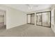 Bedroom includes a ceiling fan, carpet flooring, and mirrored closet doors at 409 Rutherford Cir, Las Vegas, NV 89123