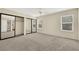 Spacious bedroom boasts mirrored closet doors, carpet flooring, and natural light at 409 Rutherford Cir, Las Vegas, NV 89123