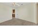 Bright, neutral bedroom features carpet flooring and a glimpse into the hall at 409 Rutherford Cir, Las Vegas, NV 89123