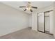 Bedroom featuring neutral carpet, mirrored closet and ceiling fan at 409 Rutherford Cir, Las Vegas, NV 89123