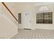 Bright foyer with tiled flooring, white front door with glass, and high ceilings with big windows at 409 Rutherford Cir, Las Vegas, NV 89123