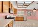 Well-lit kitchen with wood cabinets, white countertops, stainless steel appliances, and tiled floor at 409 Rutherford Cir, Las Vegas, NV 89123